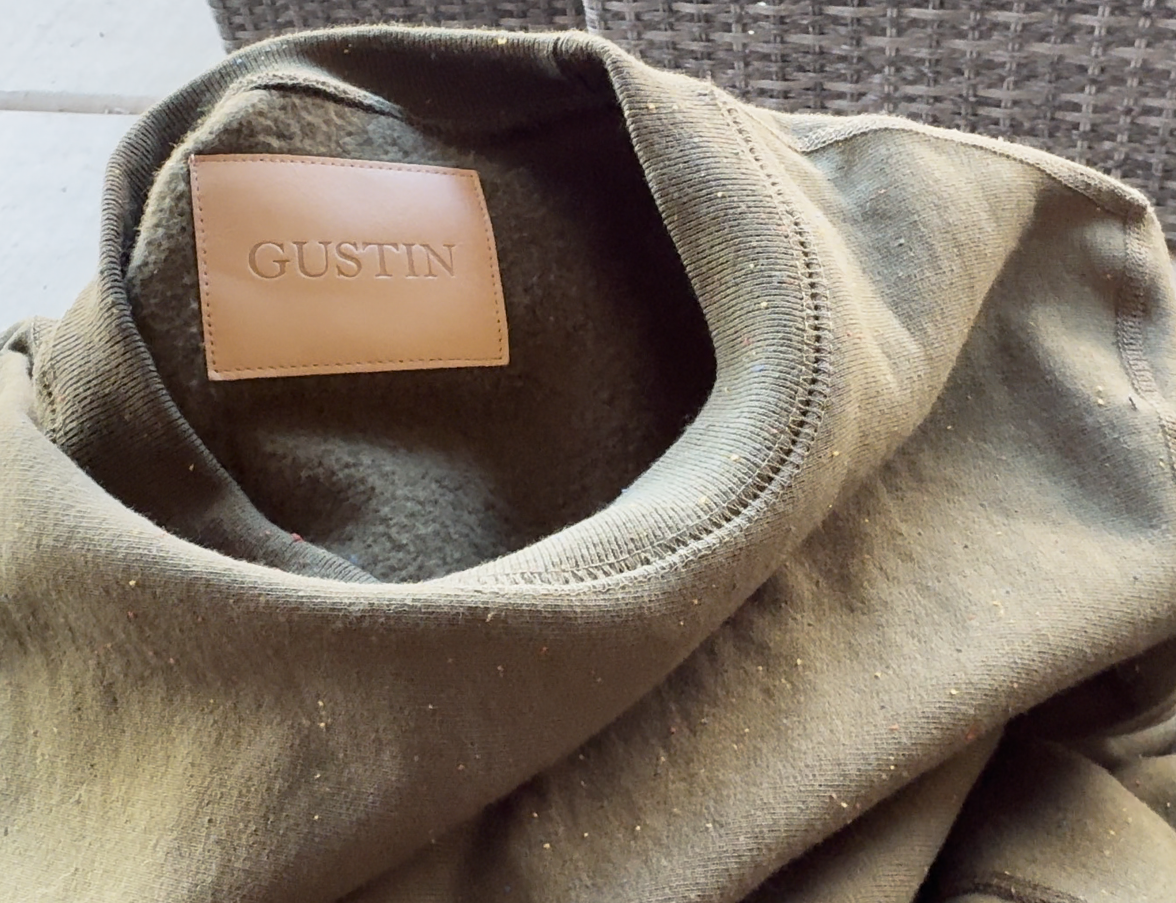 Gustin leather patch inside of an army green rainbow nep sweatshirt