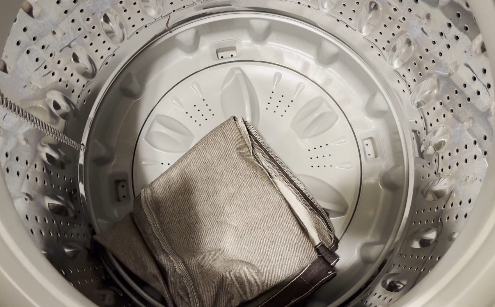 Folded, inside-out Levi's 501 sitting in empty washing machine