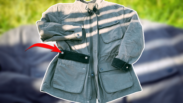 A red arrow pointing to a pocket detail on a nylon-cotton blend field jacket