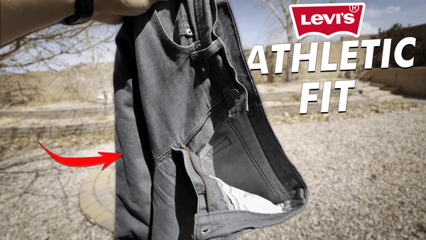 Holding up a pair of raw gray Levi's 541 athletic fit denim jeans