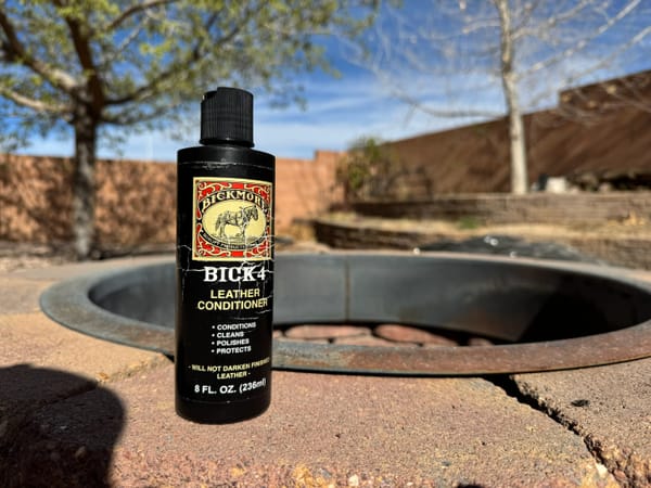 A bottle of Bick 4 sitting outdoors, atop a fire pit
